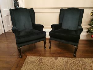 Pair of green velvet upholstered wingback armchairs