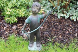 Bronze boy water feature with hose fountain